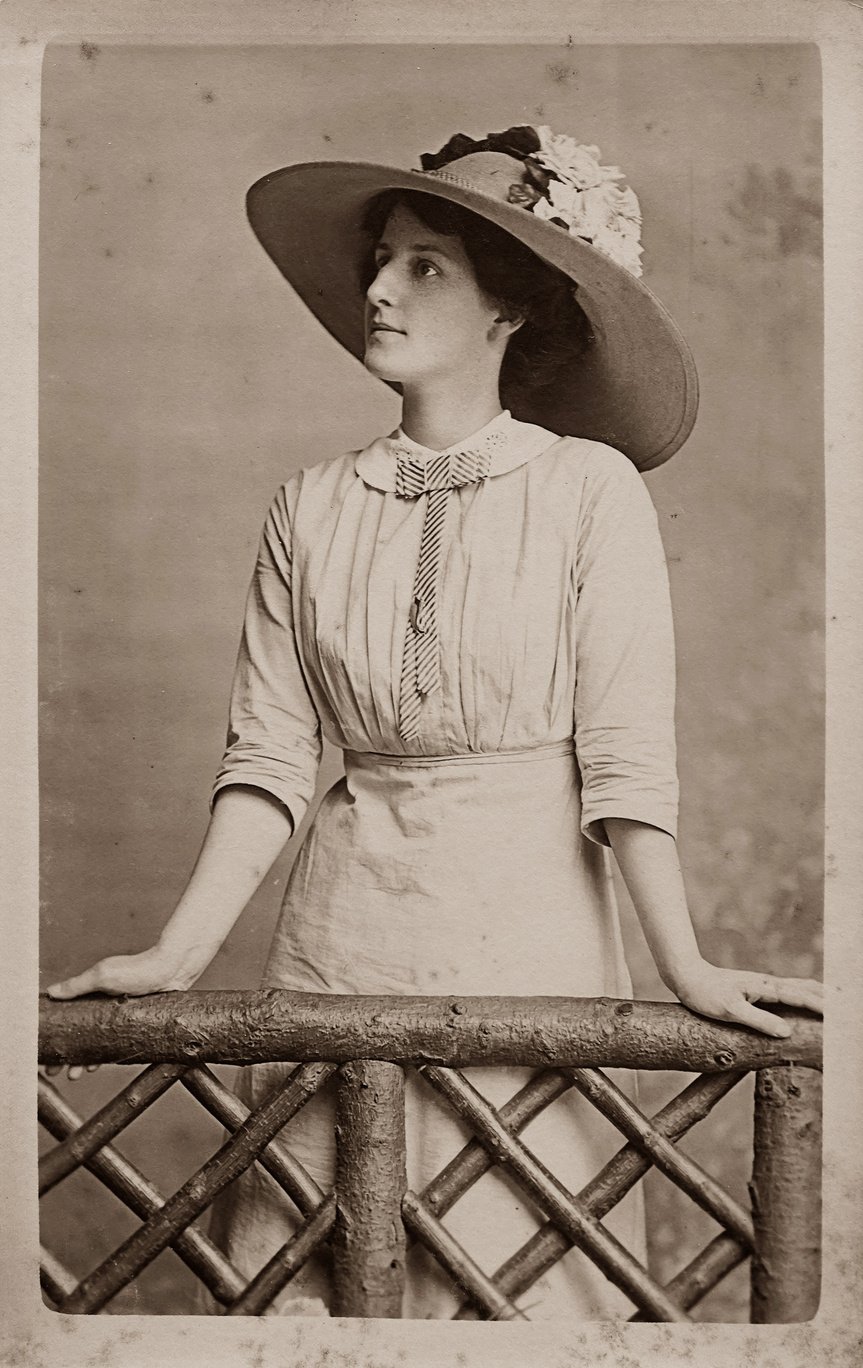 Old Photo of Woman in White Dress And Hat With Flowers